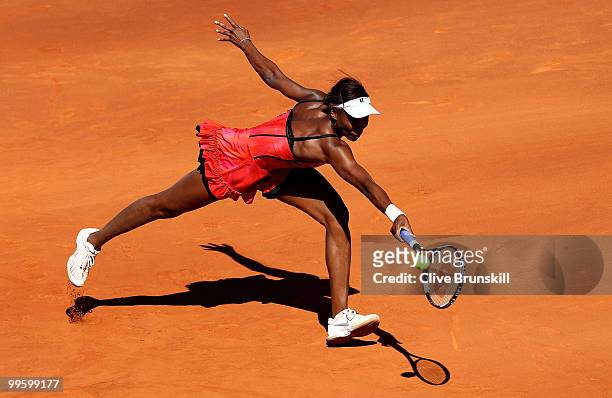 Venus Williams of the USA stretches to reach a backhand against Aravane Rezai of France in the womens final match during the Mutua Madrilena Madrid...