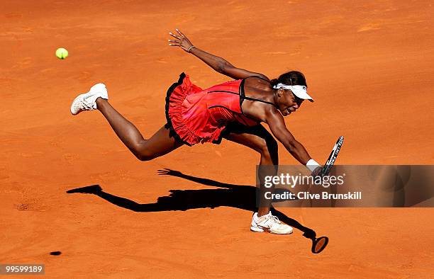 Venus Williams of the USA stretches to reach a backhand against Aravane Rezai of France in the womens final match during the Mutua Madrilena Madrid...