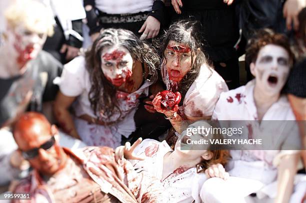 Group of people wearing zombie costumes pose during a zombie walk on the Croisette at the 63rd Cannes Film Festival on May 16, 2010 in Cannes. Photo...