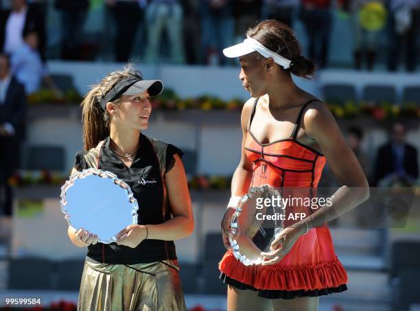 French Aravane Rezai and US Venus Williams celebrate with their trophies after their final match of the Madrid Masters on May 16, 2010 at the Caja...