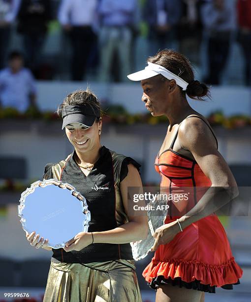 French Aravane Rezai and US Venus Williams celebrate with their trophies after their final match of the Madrid Masters on May 16, 2010 at the Caja...
