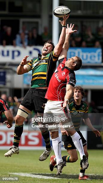 Phil Dowson jumps for the high ball against Justin Melck during the Guinness Premiership semi final match between Northampton Saints and Saracens at...