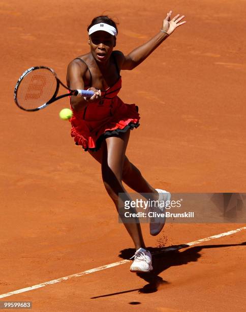 Venus Williams of the USA leaps to reach a forehand against Aravane Rezai of France in the womens final match during the Mutua Madrilena Madrid Open...