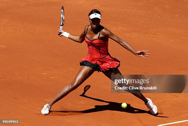 Venus Williams of the USA stretches to reach a forehand against Aravane Rezai of France in the womens final match during the Mutua Madrilena Madrid...