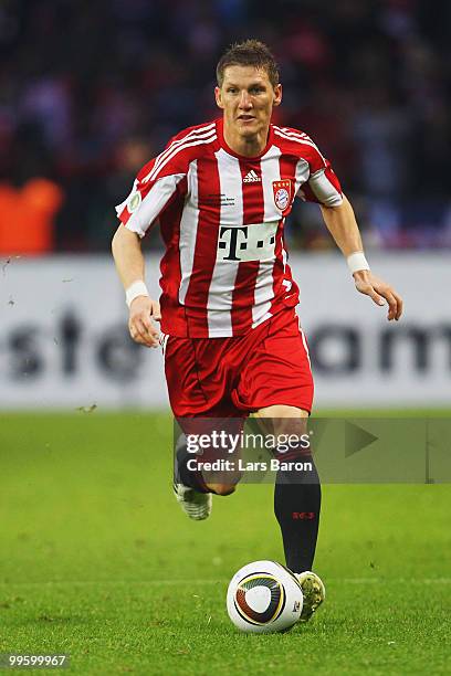 Bastian Schweinsteiger of Bayern runs with the ball during the DFB Cup final match between SV Werder Bremen and FC Bayern Muenchen at Olympic Stadium...