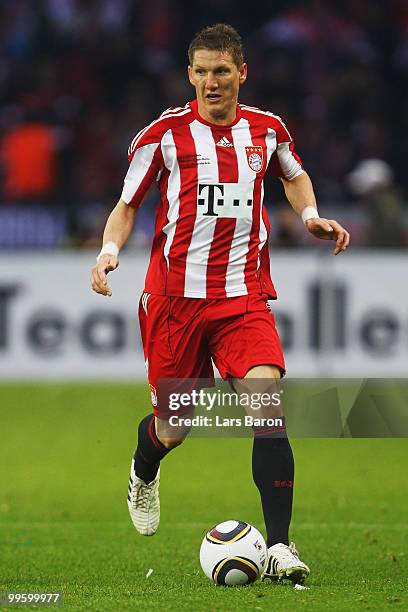 Bastian Schweinsteiger of Bayern runs with the ball during the DFB Cup final match between SV Werder Bremen and FC Bayern Muenchen at Olympic Stadium...