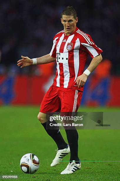 Bastian Schweinsteiger of Bayern runs with the ball during the DFB Cup final match between SV Werder Bremen and FC Bayern Muenchen at Olympic Stadium...