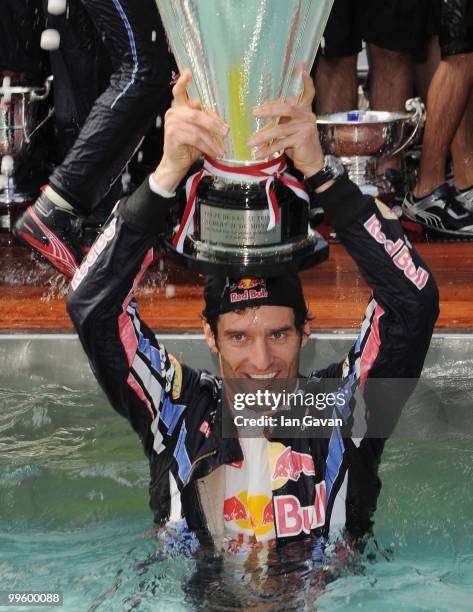 Red Bull's Australian Driver Mark Webber celebrates in the pool after winning the Monaco Grand Prix 2010 at the Red Bull Formula 1 Energy Station on...