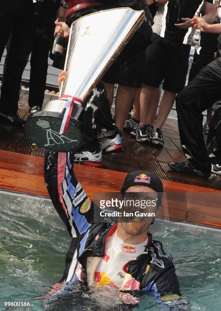 Red Bull's Australian Driver Mark Webber celebrates in the pool after winning the Monaco Grand Prix 2010 at the Red Bull Formula 1 Energy Station on...
