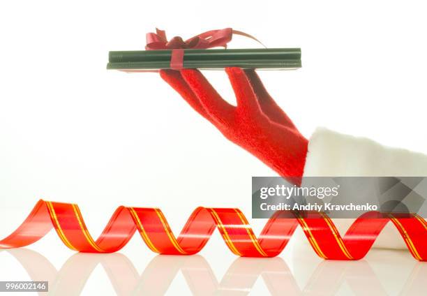 hand in red glove holds electronic book reader against white background - e reader - fotografias e filmes do acervo