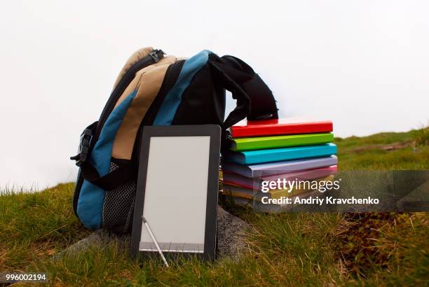 stack of colorful books and electronic book reader - e reader - fotografias e filmes do acervo