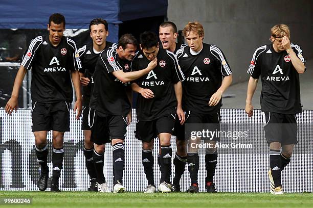 Ilkay Guendogan of Nuernberg celebrates his team's first goal with team mates during the Bundesliga play off leg two match between FC Augsburg and 1....