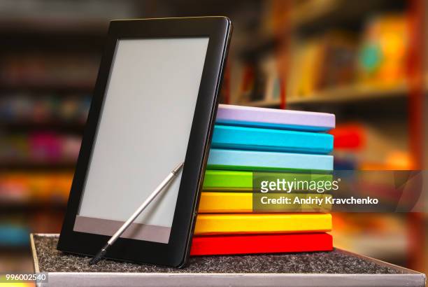 stack of colorful books with electronic book reader - e reader - fotografias e filmes do acervo