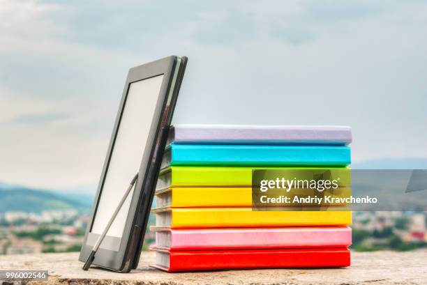 stack of colorful books with electronic book reader - e reader - fotografias e filmes do acervo