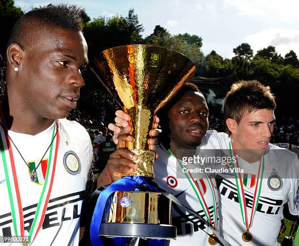 Mario Balotelli, Sulley Muntari and Davide Santon of FC Internazionale Milano celebrate with tthe trophy after winning the league during the Serie A...