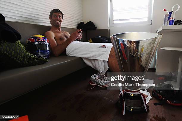 Mark Webber of Australia and Red Bull Racing relaxes in his changing room after ending up in the harbour while celebrating his victory in the Monaco...