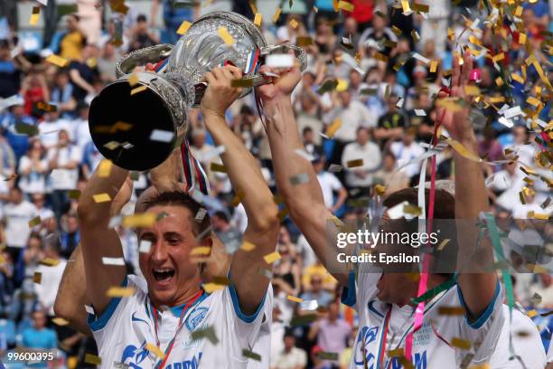 Vladimir Bystrov and Konstantin Zyryanov of FC Zenit St. Petersburg celebrate with the trophy at the end of the Russian Cup final match between FC...