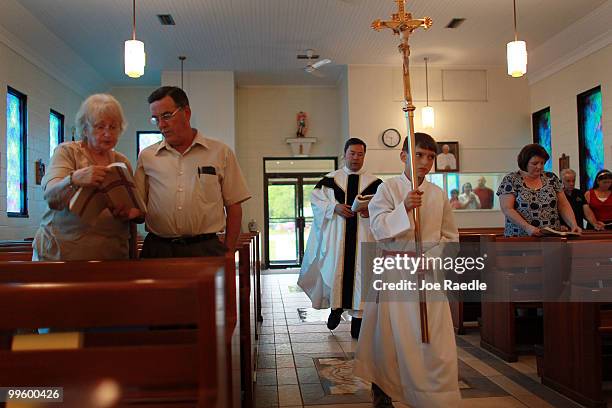 Father Bill Nguyen follows Rush Lyons during a procession at the Saint Michael's Church where prayers for the outcome of the Deepwater Horizon oil...