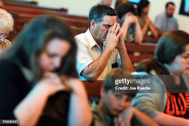 Phil Lyons prays with others at the Saint Michael's Church where Father Bill Nguyen included prayers for the outcome of the Deepwater Horizon oil...