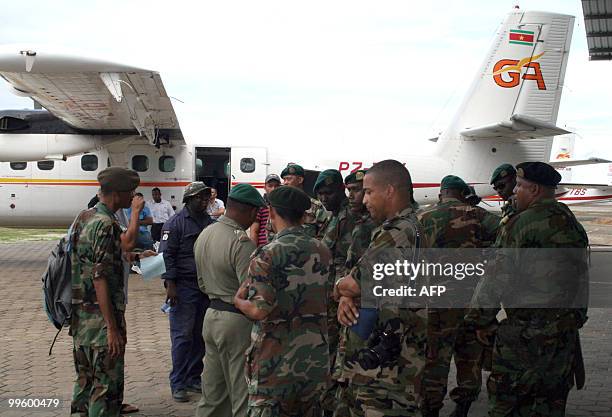 Surinam army soldiers stand by to depart in search of the Blue Wings Airlines twin-engine Antonov AN-28 that crashed Saturday night near the border...