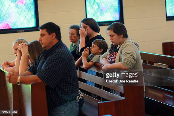 Cort Johnson prays along with his father Sean Johnson , who owns a seafood processiong business, and the rest of the family at the Saint Michael's...