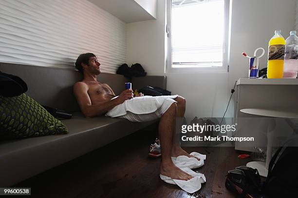 Mark Webber of Australia and Red Bull Racing relaxes in his changing room after ending up in the harbour while celebrating his victory in the Monaco...