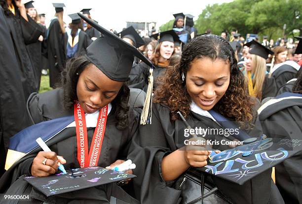 Students decorate their caps before the 2010 George Washington University commencement at the National Mall on May 16, 2010 in Washington, DC.