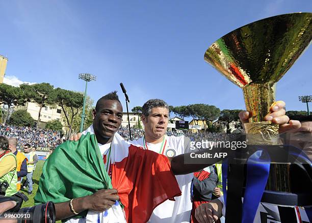 Inter Milan's forward Mario Balotelli celebrates with the trophy after his team defeated Siena 1-0 to win the Italian Serie A title on May 16, 2010...