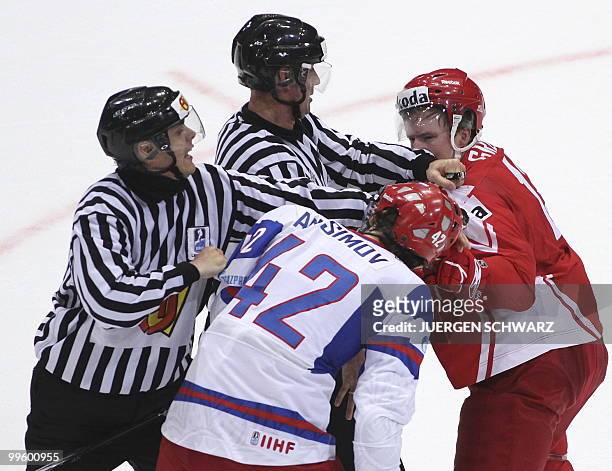 The officals try to stop Denmark's Morten Green and Russia's Artyom Anisimov from fighting during the IIHF Ice Hockey World Championship match...