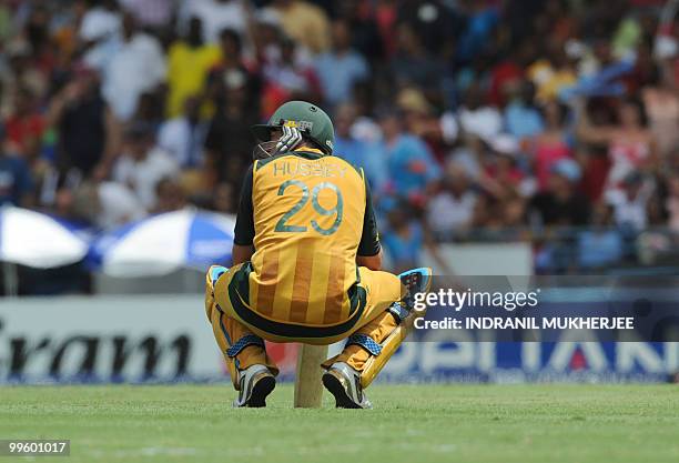 Australian cricketer David Hussey waits for the third umpire's decision after being run out by England cricketer Craig Kieswetter during the Men's...
