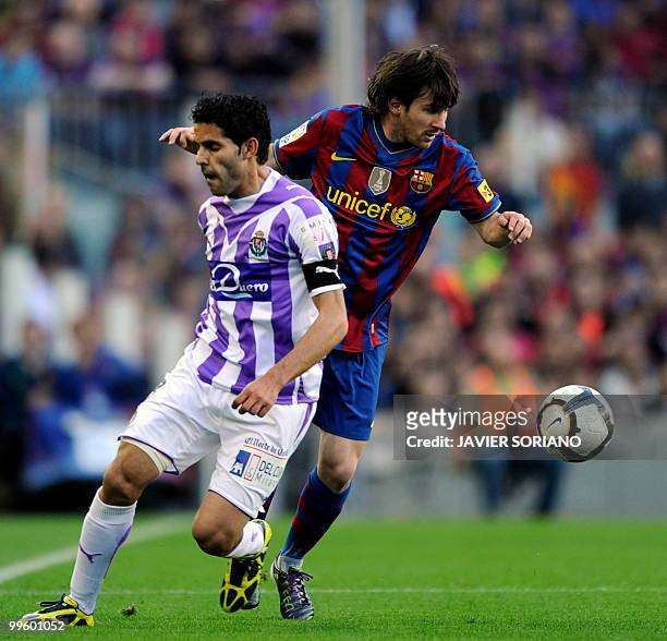 Barcelona's Argentinian forward Lionel Messi vies with Valladolid's defender Javier Baraja during the Spanish League football match between...