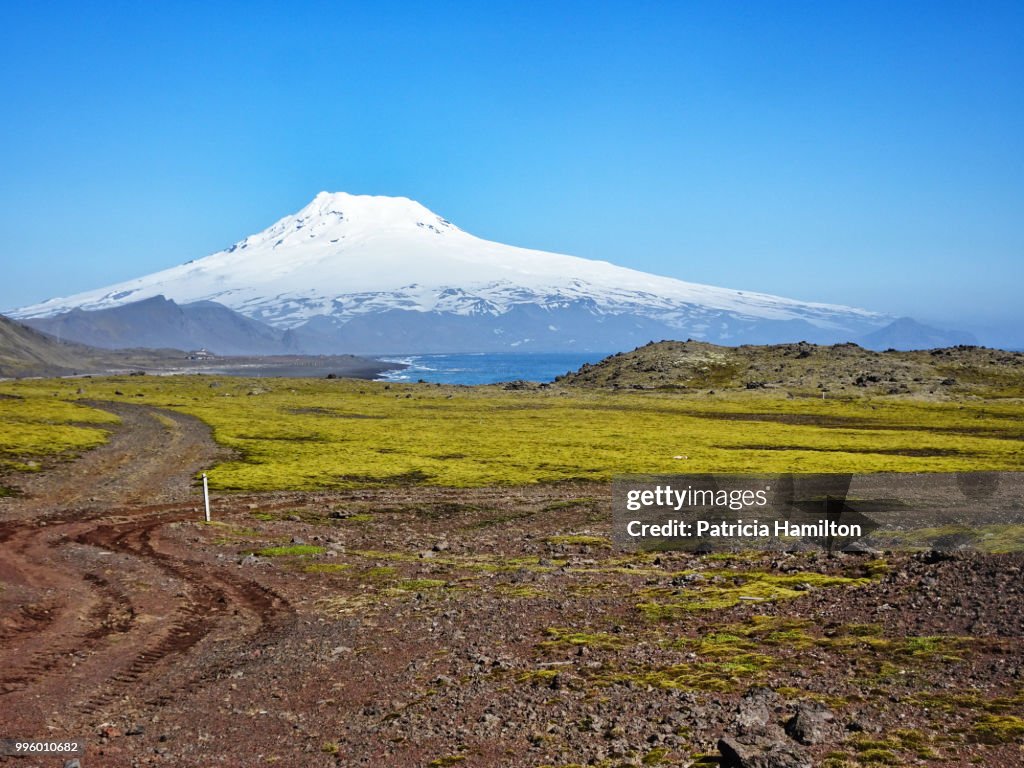 Dirt track with Beerenberg volcano in background