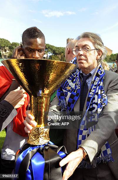 Inter Milan's President Massimo Moratti and forward Mario Balotelli celebrate with the trophy after his team defeated Siena 1-0 to win the Italian...