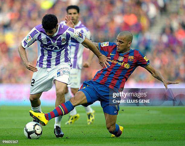 Barcelona's Brazilian defender Dani Alves vies with Valladolid's Brazilian midfielder Diego Costa during their Spanish League football match between...