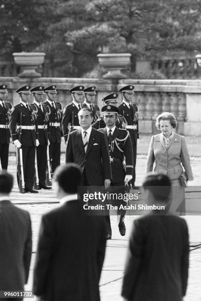 British Prime Minister Margaret Thatcher reviews the honour guard with Japanese Prime Minister Yasuhiro Nakasone during the welcome ceremony ahead of...