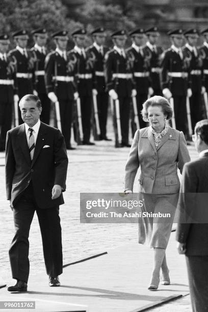 British Prime Minister Margaret Thatcher reviews the honour guard with Japanese Prime Minister Yasuhiro Nakasone during the welcome ceremony ahead of...