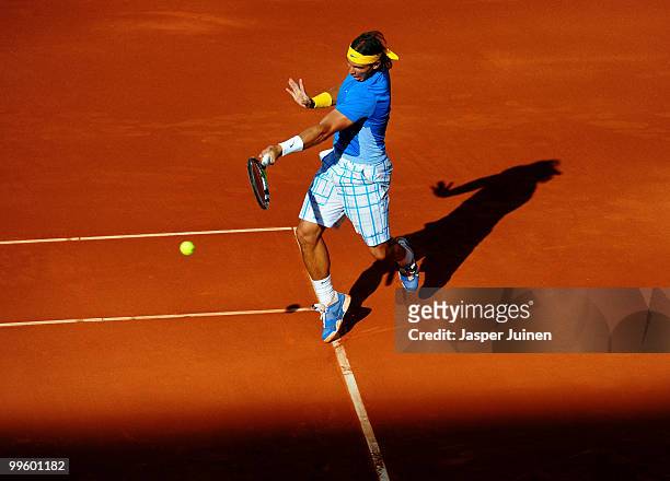 Rafael Nadal of Spain plays a backhand to Roger Federer of Switzerland in their final match during the Mutua Madrilena Madrid Open tennis tournament...