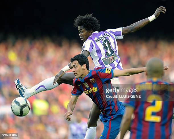 Barcelona's midfielder Sergio Busquets vies with Valladolid's Angolan forward Manucho during the Spanish League football match between Barcelona and...