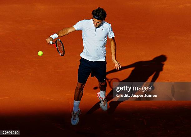 Roger Federer of Switzerland plays a backhand to Rafael Nadal of Spain in their final match during the Mutua Madrilena Madrid Open tennis tournament...