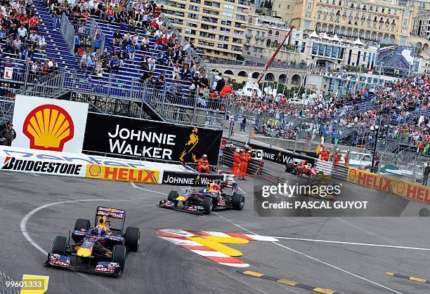 Red Bull's Australian driver Mark Webber drives ahead of Red Bull's German driver Sebastian Vettel and Renault f1's Polish driver Robert Kubica at...