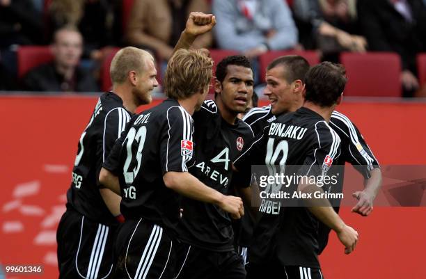 Eric-Maxim Choupo-Moting of Nuernberg celebrates his team's second goal with team mates during the Bundesliga play off leg two match between FC...