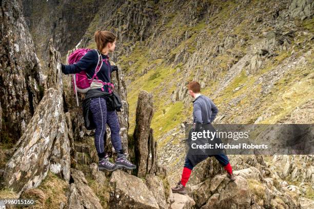 hikers on striding edge and helvellyn in the lake district national park - ambleside stock pictures, royalty-free photos & images