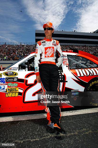 Joey Logano, driver of the The Home Depot Toyota, stands on the grid prior to the NASCAR Sprint Cup Series Autism Speaks 400 at Dover International...