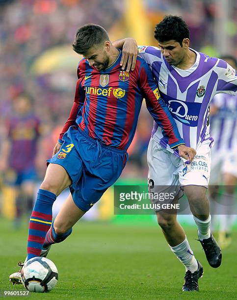 Barcelona's defender Gerard Pique vies with Valladolid's Brazilian midfielder Diego Costa during the Spanish League football match between Barcelona...