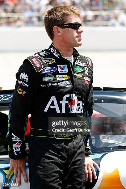 Carl Edwards, driver of the Aflac Ford, leans on his car on the grid prior to the NASCAR Sprint Cup Series Autism Speaks 400 at Dover International...