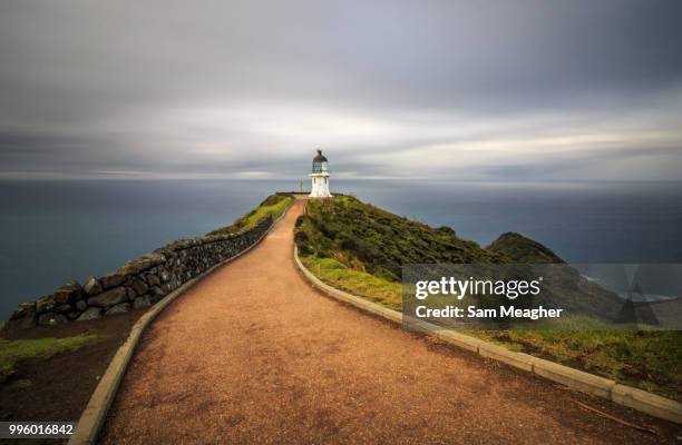 where two sea's meet, cape reinga lighthouse - cape reinga lighthouse stock pictures, royalty-free photos & images