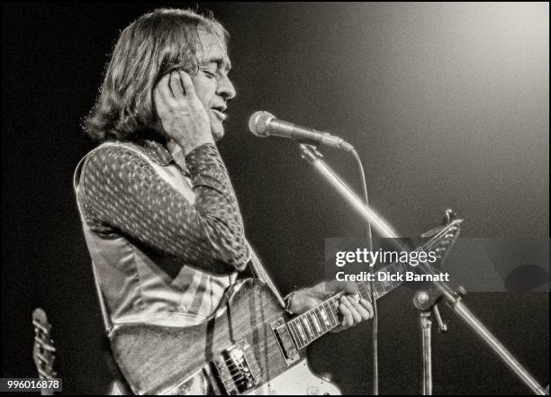 Dave Mason performs on stage at Hammersmith Odeon, London, 1977.