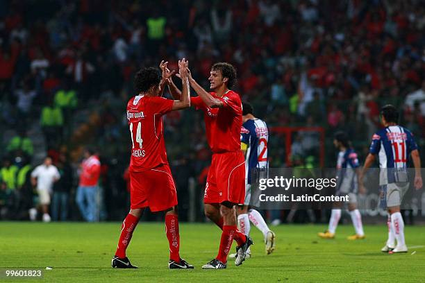 Edgar Duenas , Diego Novaretti of Toluca celebrate victory over Pachuca during a semifinal match as part of the 2010 Bicentenary Tournament at...