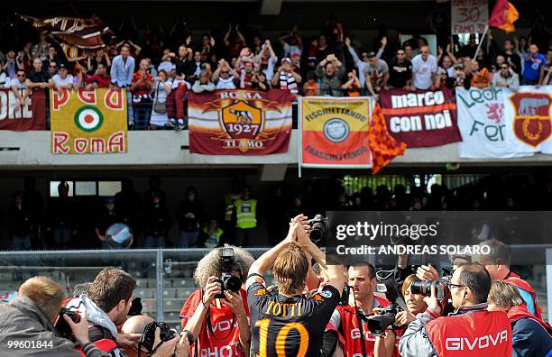 Roma's forward Francesco Totti applauds his supporters at the end of his team's Italian serie A football match against Chievo at Marc'Antonio...