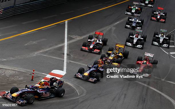 Mark Webber of Australia and Red Bull Racing leads the field into the first corner at the start of the Monaco Formula One Grand Prix at the Monte...